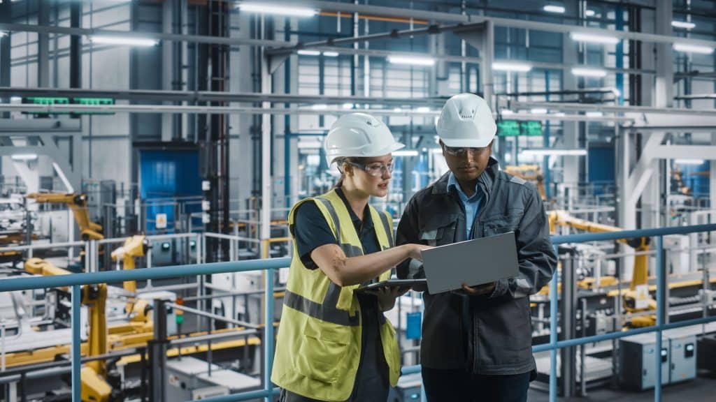 male,specialist,and,female,car,factory,engineer,talking,and,working