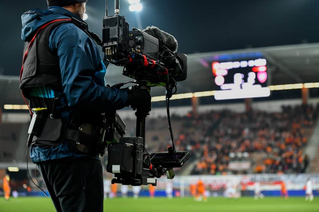 cameraman,behind,playing,field,during,soccer,match.